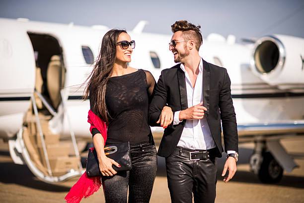 A man and woman traveling together on a private jet.