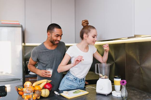 Man and woman cooking together in a cozy kitchen.