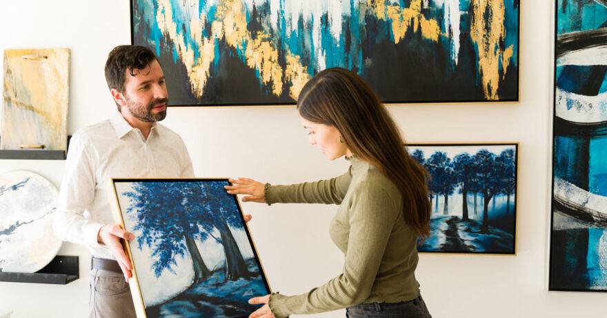 Couple exploring an art fair, discussing the artwork.